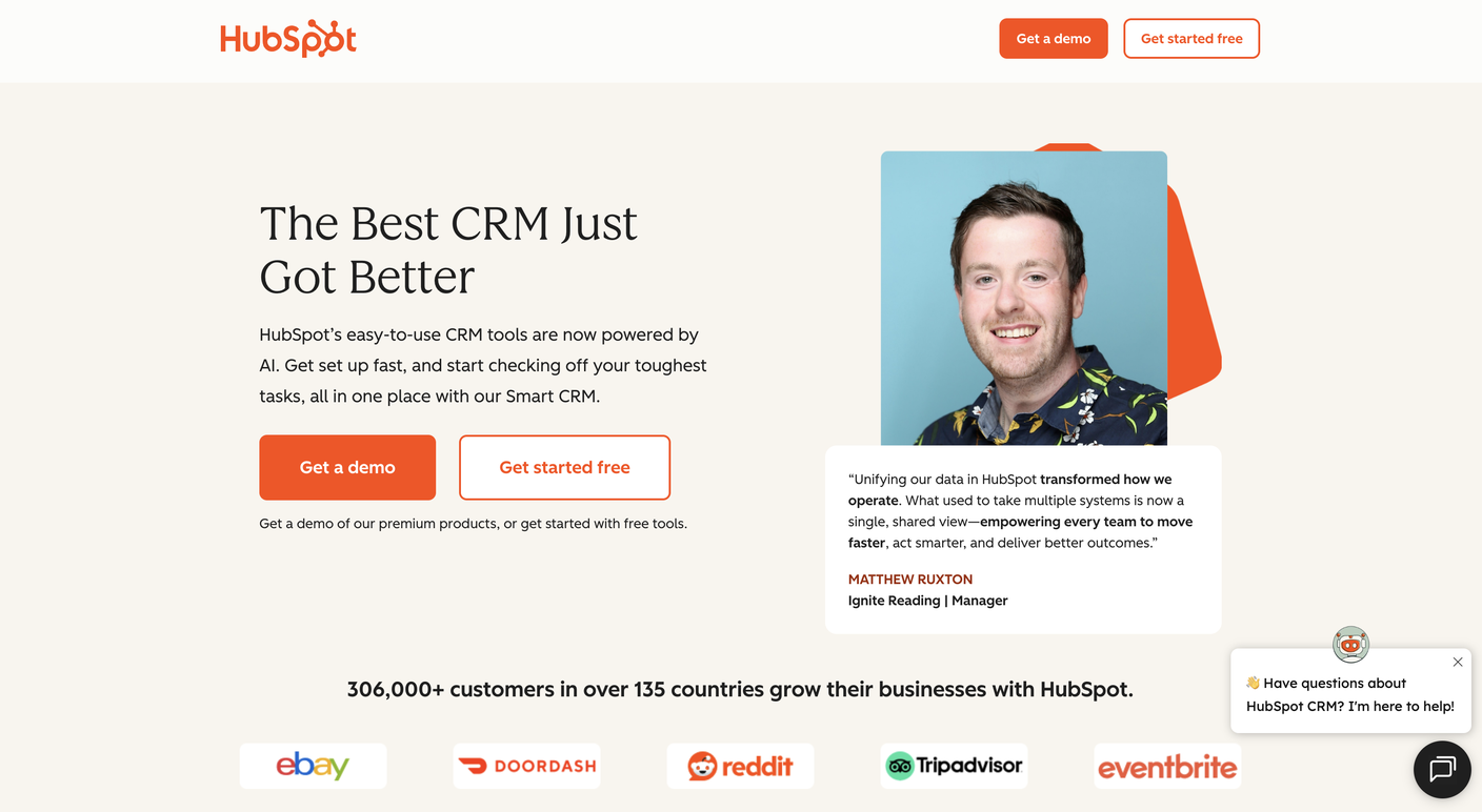 HubSpot's homepage hero with a named customer testimonial beside client logos for eBay, DoorDash, Reddit, Tripadvisor, and Eventbrite, and a line reading 306,000+ customers in over 135 countries