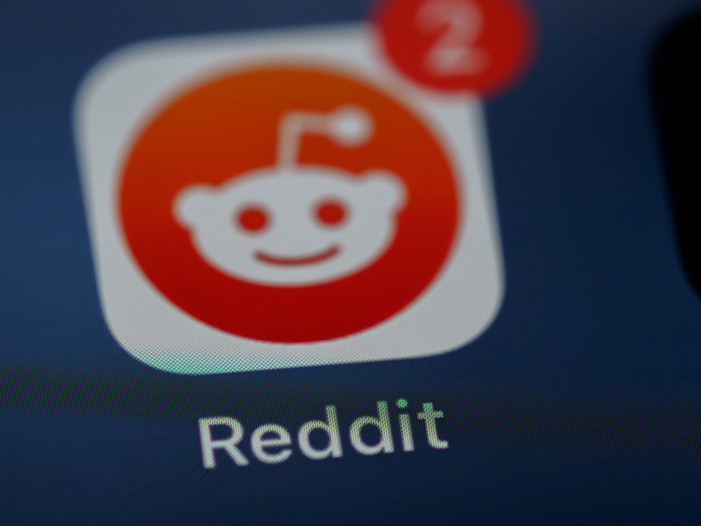 The Reddit app icon on a phone screen